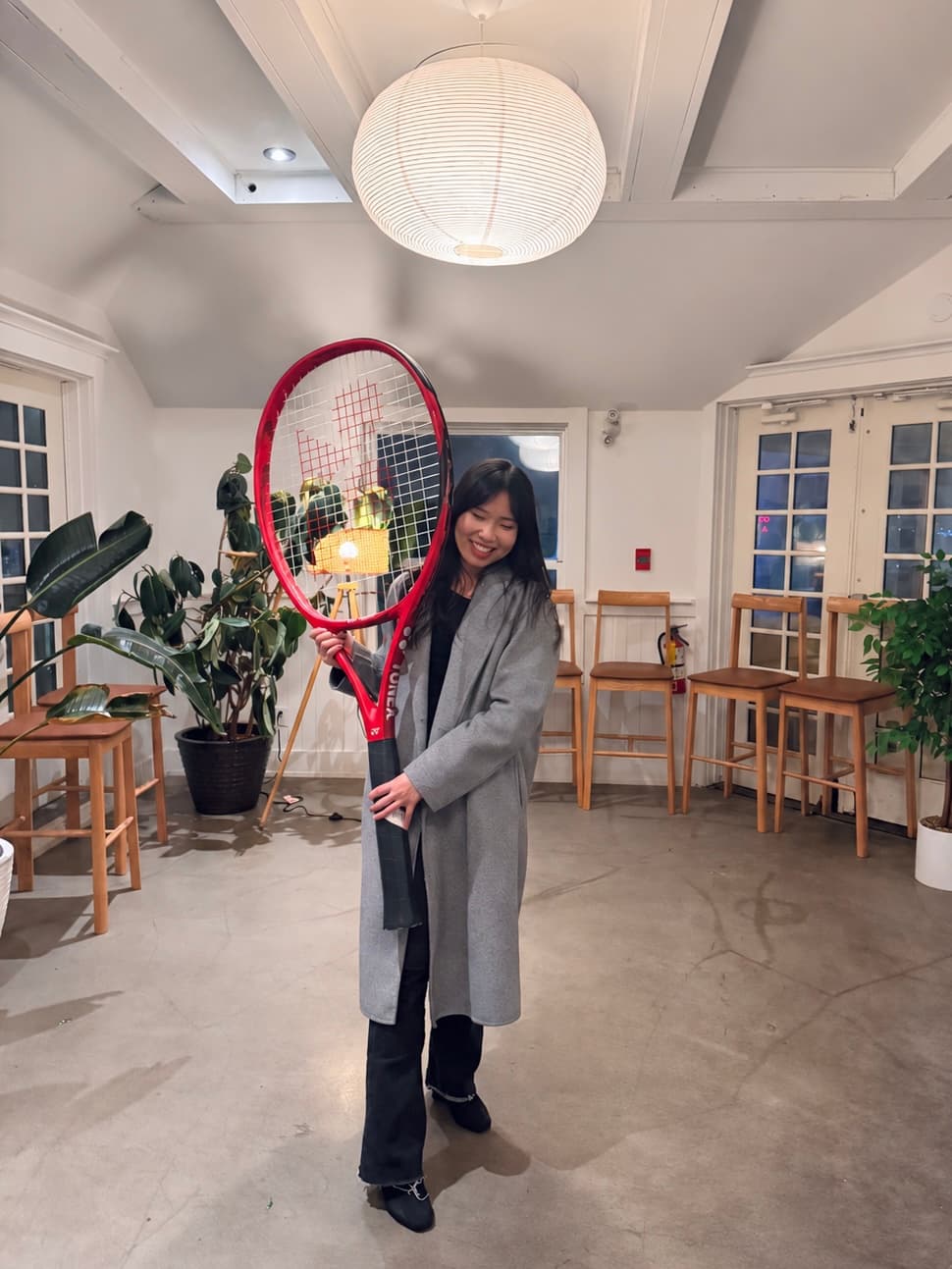 Anna holding a giant tennis racket